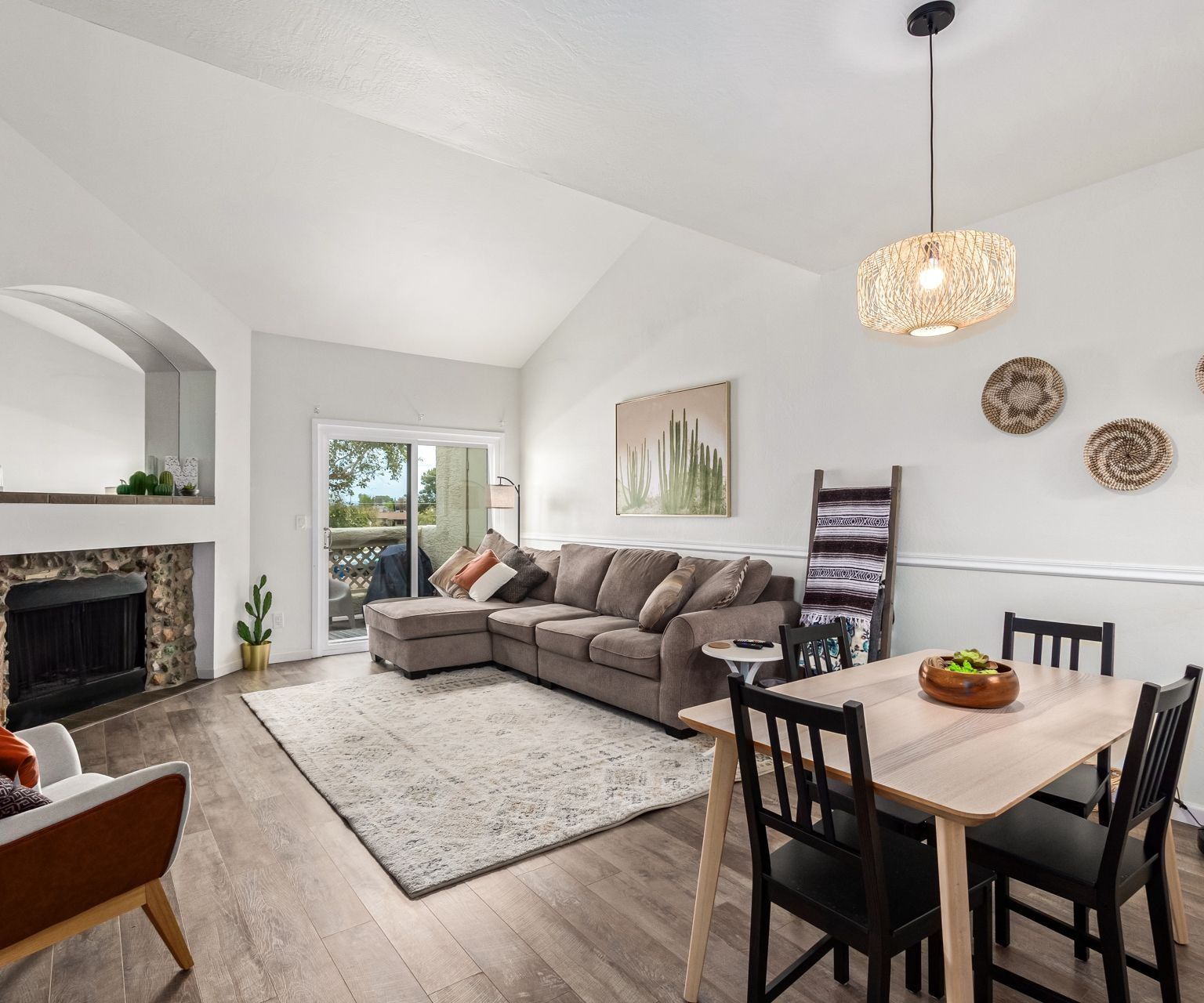 Bright Mesa condo living room with a fireplace and vaulted ceiling