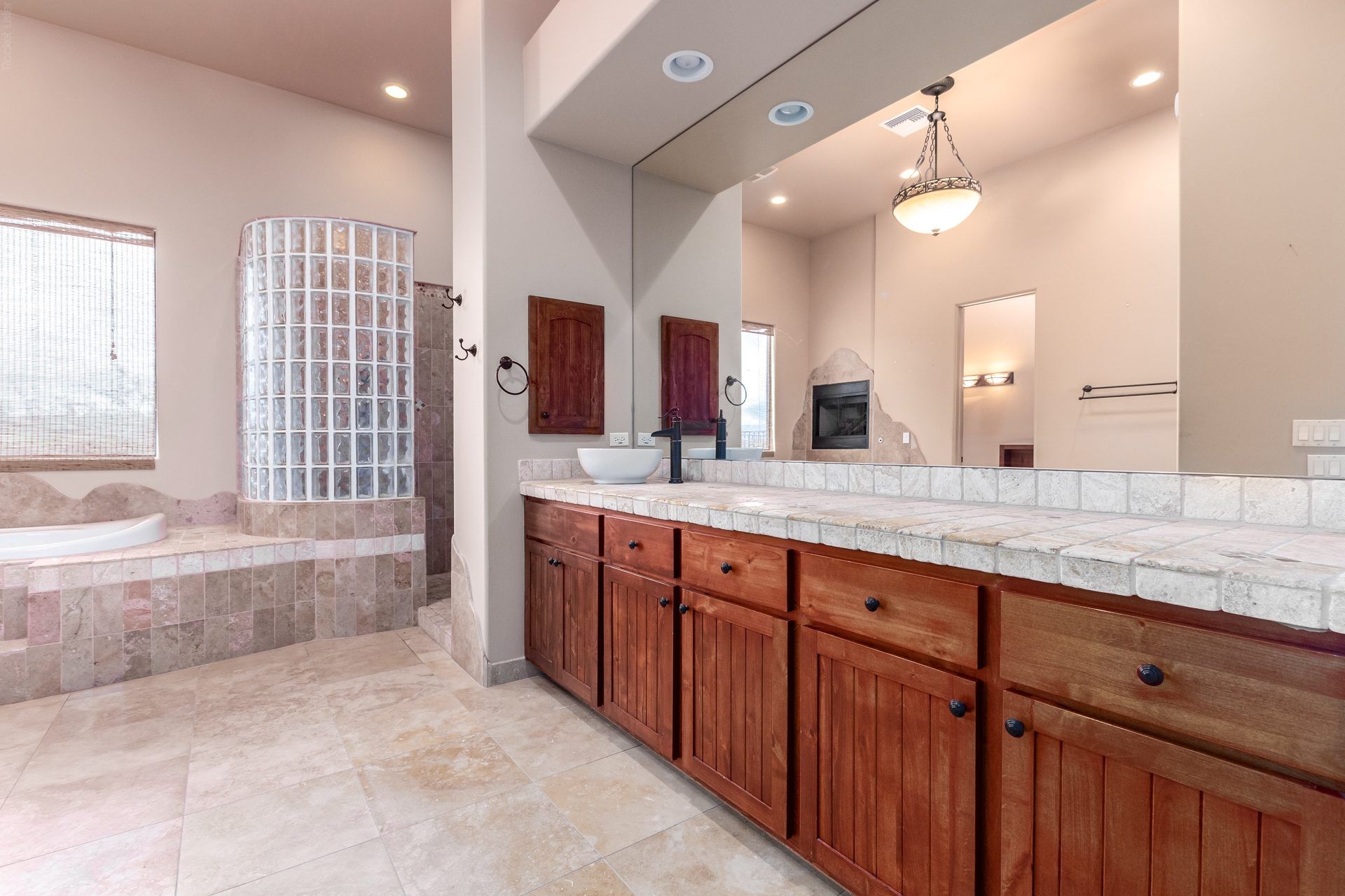 Primary bathroom with dual vanities and a soaking tub