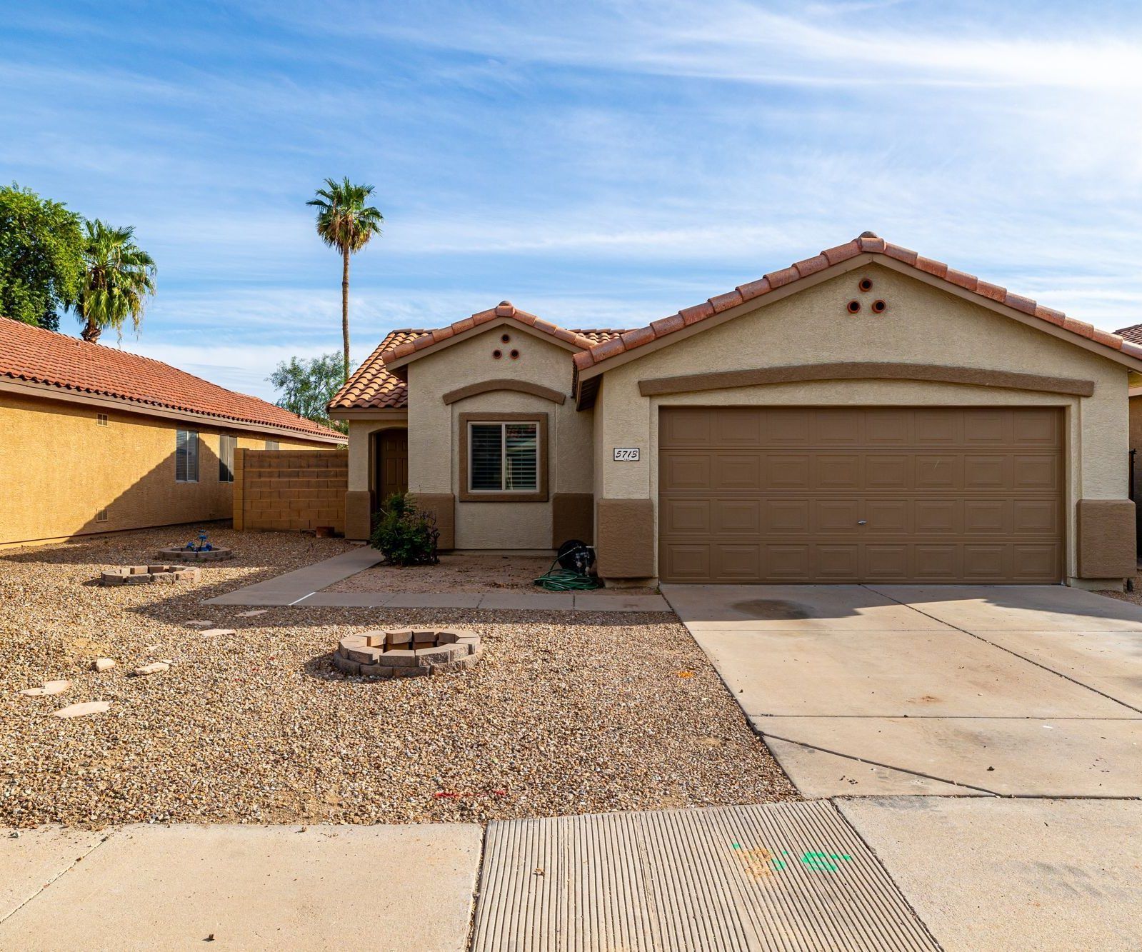 Single-story Mesa home with a two-car garage and desert landscaping